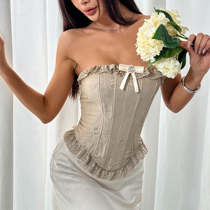 Pointed hem detail and boning seams of beige lace corset from Bare Horizon