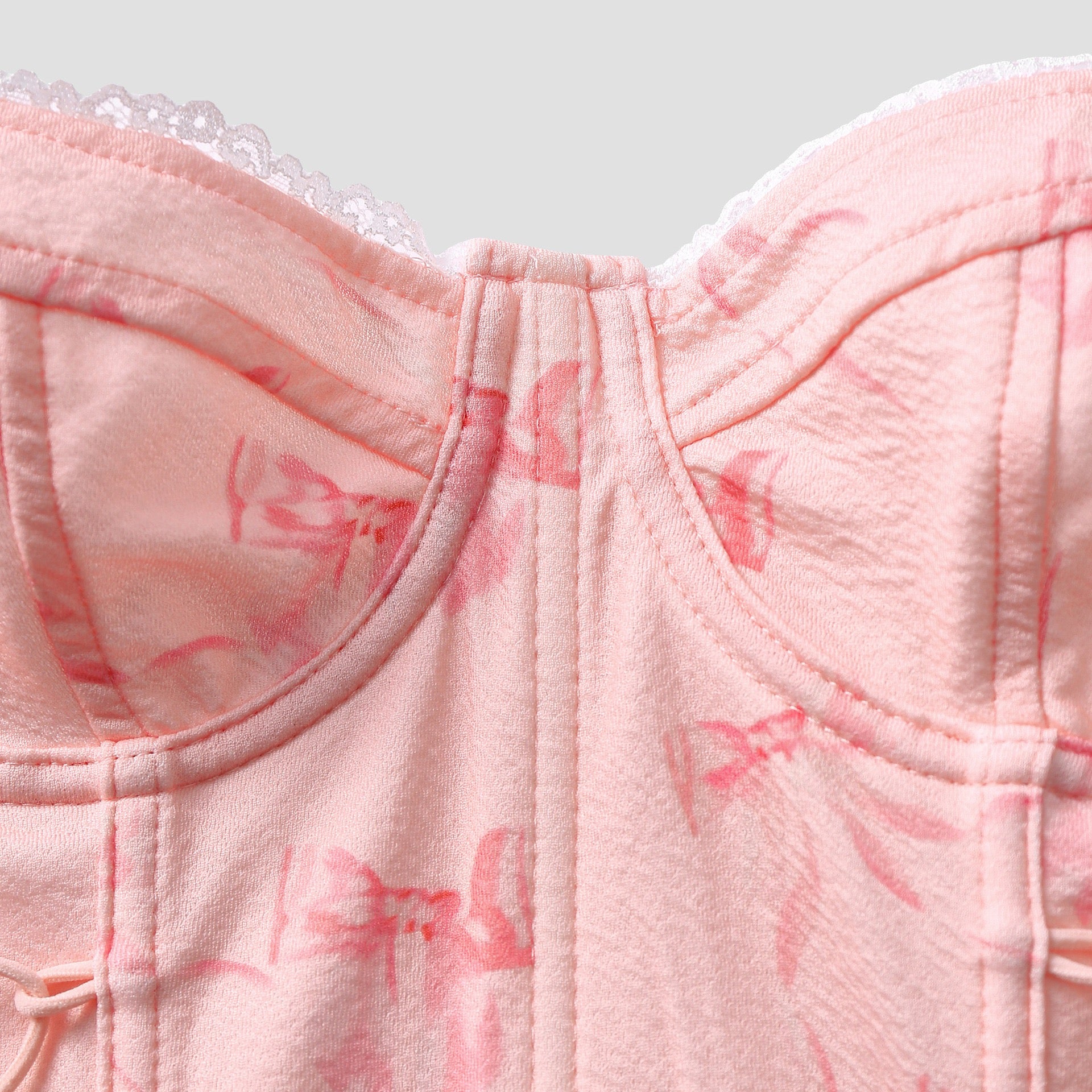 Side view of pink lace-up detail with sculpted paneling – Bare Horizon