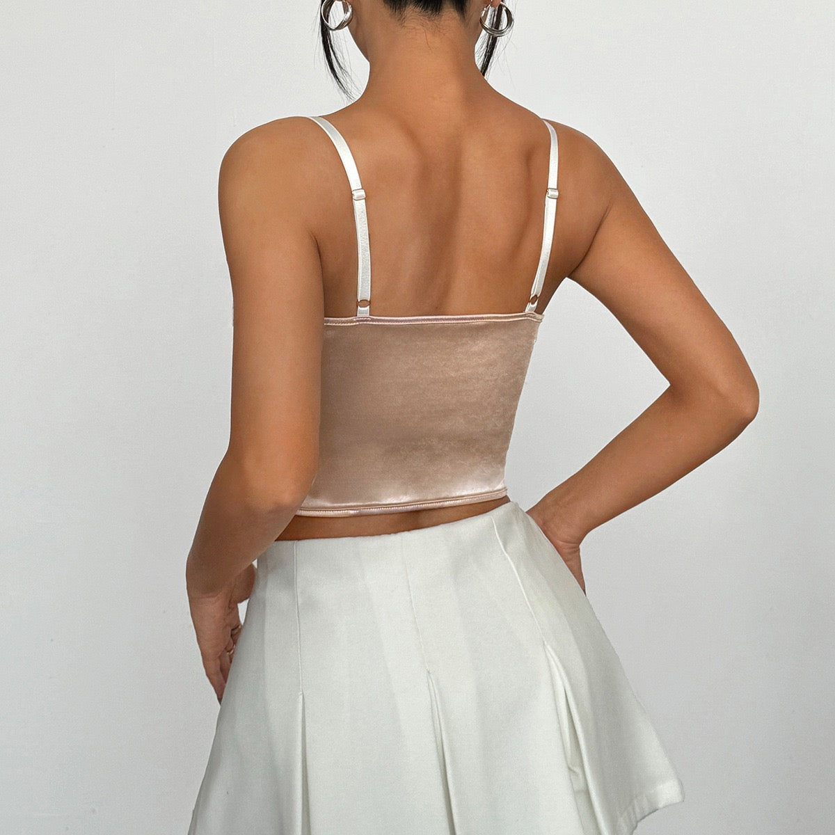 Back view of nude satin corset top with adjustable white straps